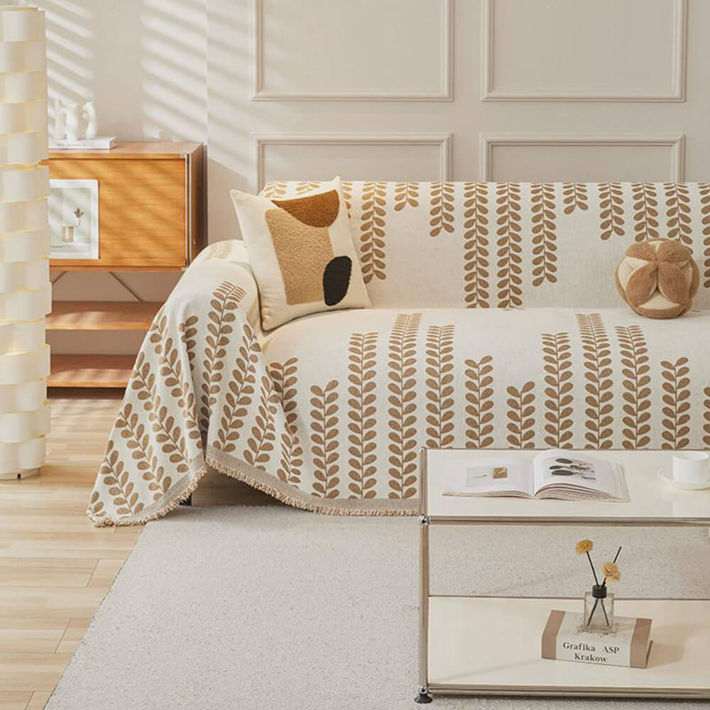 Sofaovertrekk med bladmønster og frynser – eleganse og komfort